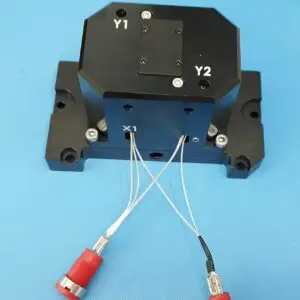IZAK NLO Kinematic Mount installed on an optical bench, demonstrating its robust and compact design. The photo captures the mount holding a nonlinear optical crystal in place, with cables neatly connected for high-voltage application.